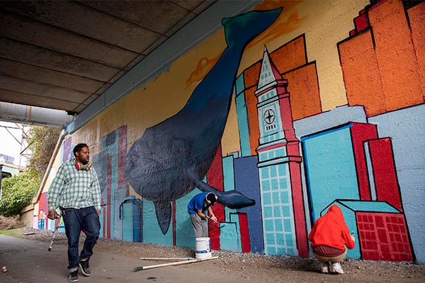 Students painting 'Hope and Resistance' mural on East Boston Greenway